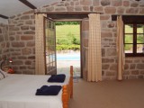 Bedroom 1 with door to the pool terrace